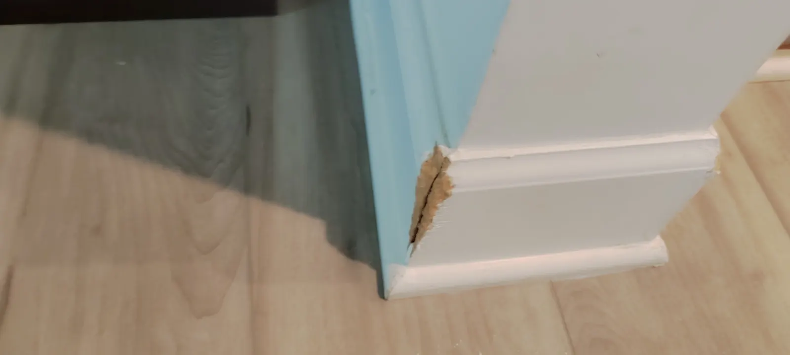 Missing material at the edge of the baseboard