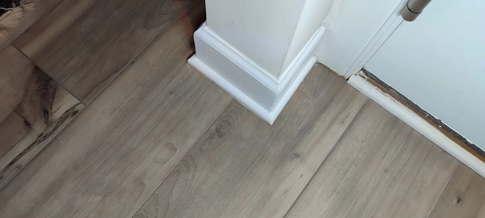 Repaired baseboard corner beside the doorway