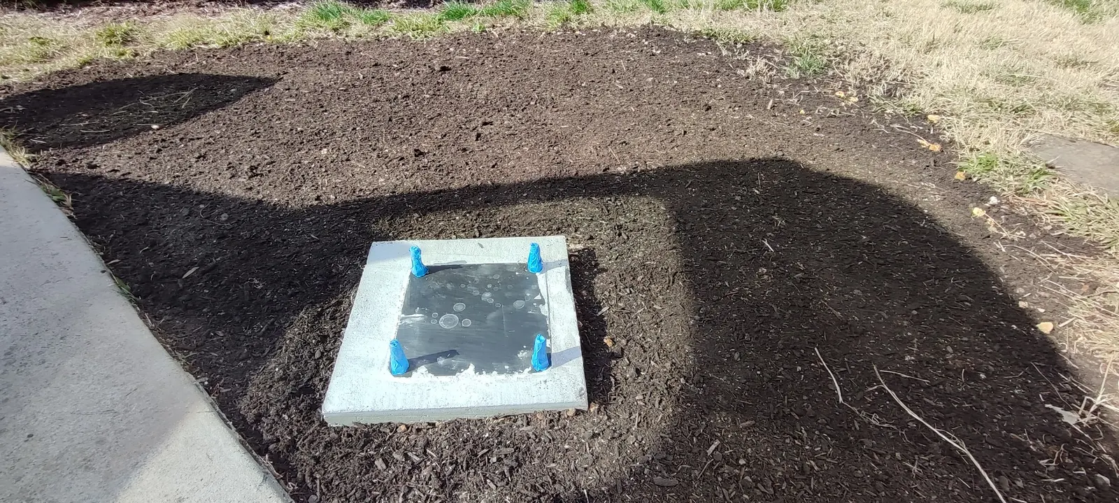 Closer view of the concrete footing and anchor plate