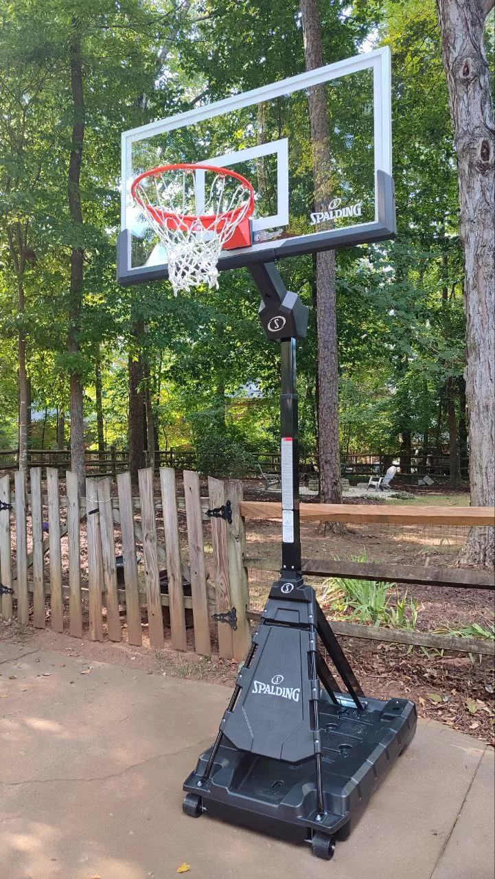 Installed portable basketball hoop with backboard and rim on an outdoor court.