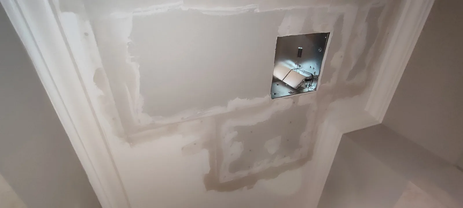 Bathroom ceiling drywall repair during joint compound and finishing work