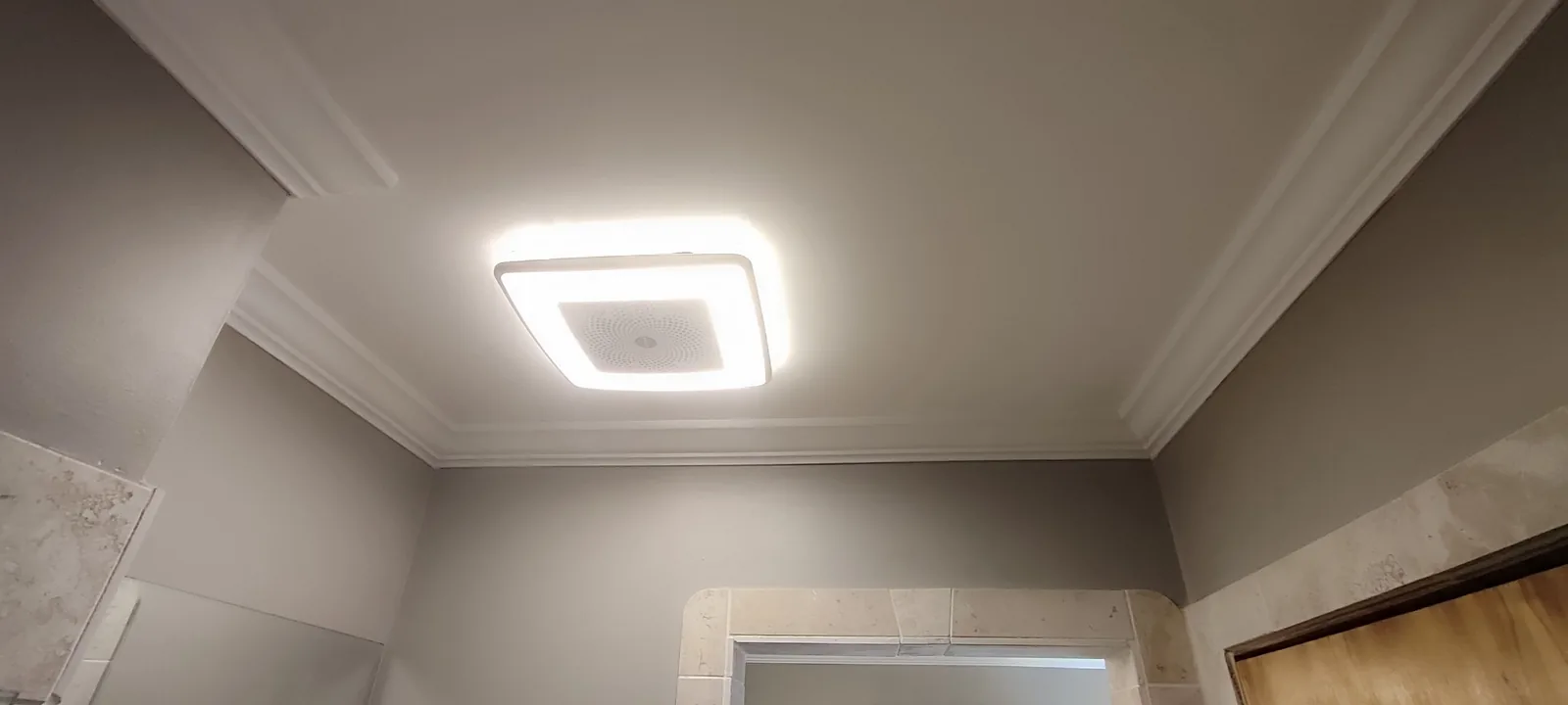 Restored and painted bathroom ceiling with the new exhaust fan and light installed