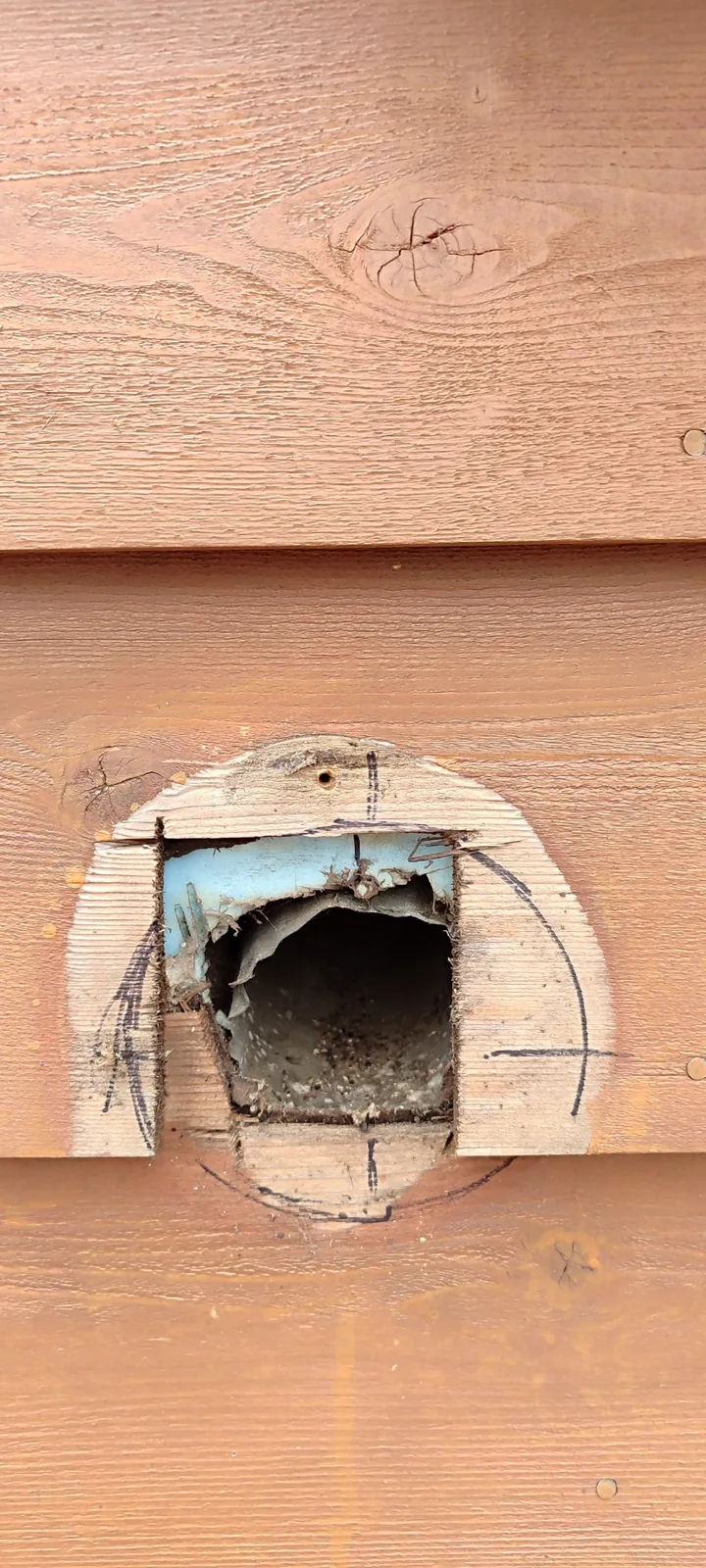 Bathroom exhaust duct opening exposed during preparation for the new exterior vent hood