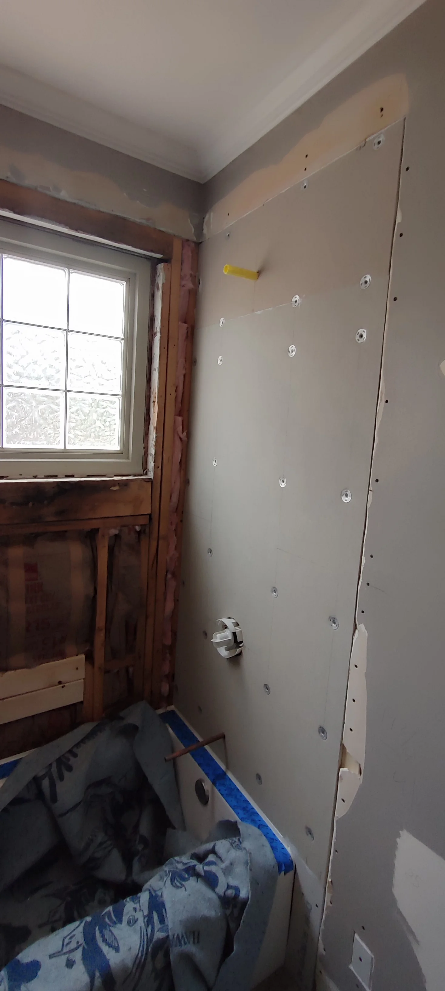 Wall boards fitted on the shower side before tiling.