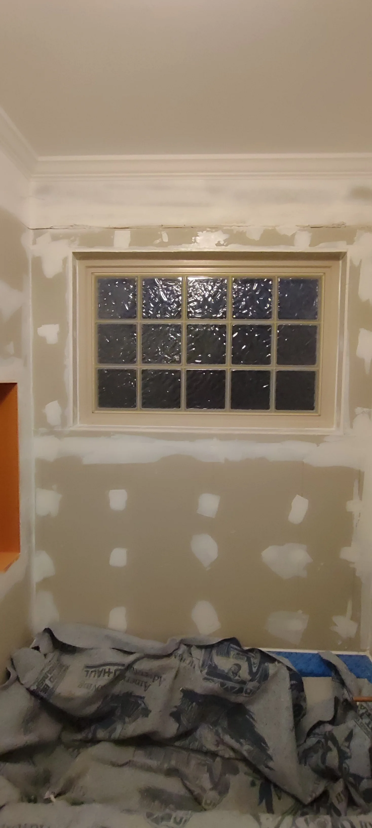 Boarded bath surround with joints covered, before the tiles were fitted.