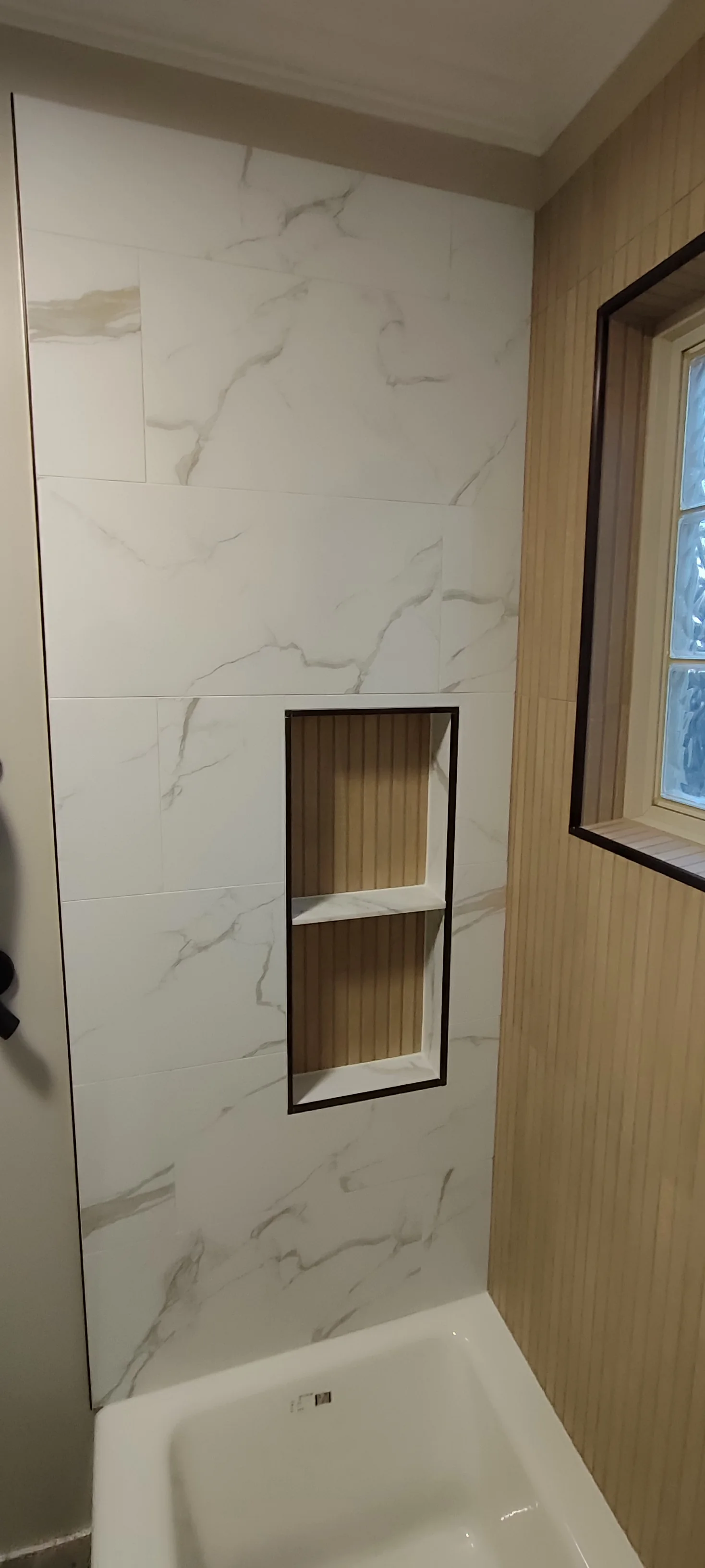 Tiled recessed niche with two compartments, photographed before the bathroom was put back into use.