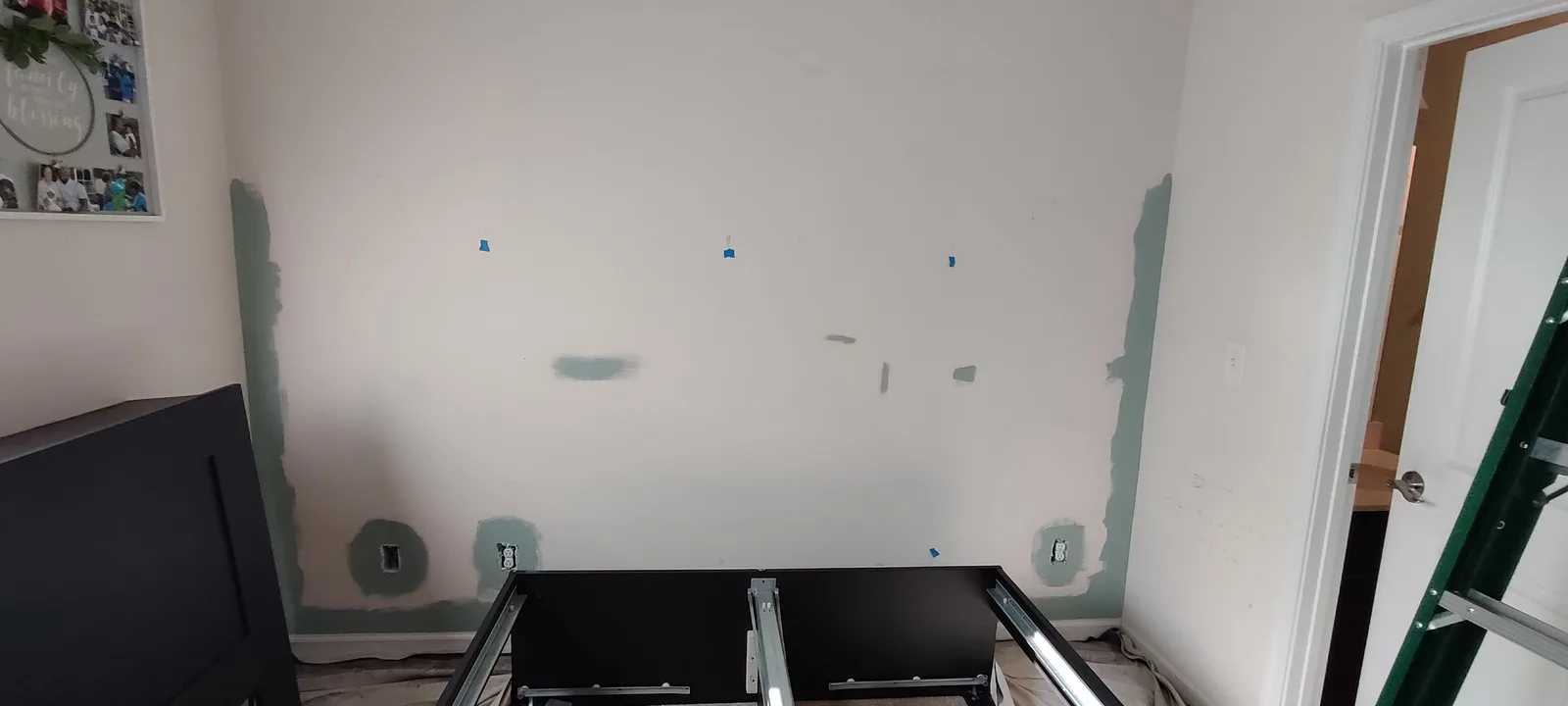 Bedroom wall with small repaired holes before painting.