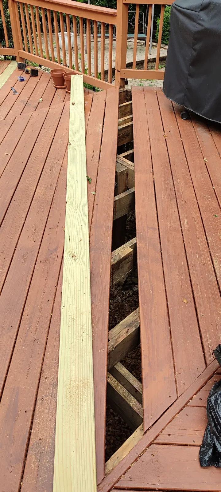 Open deck-board section with the replacement board alongside it