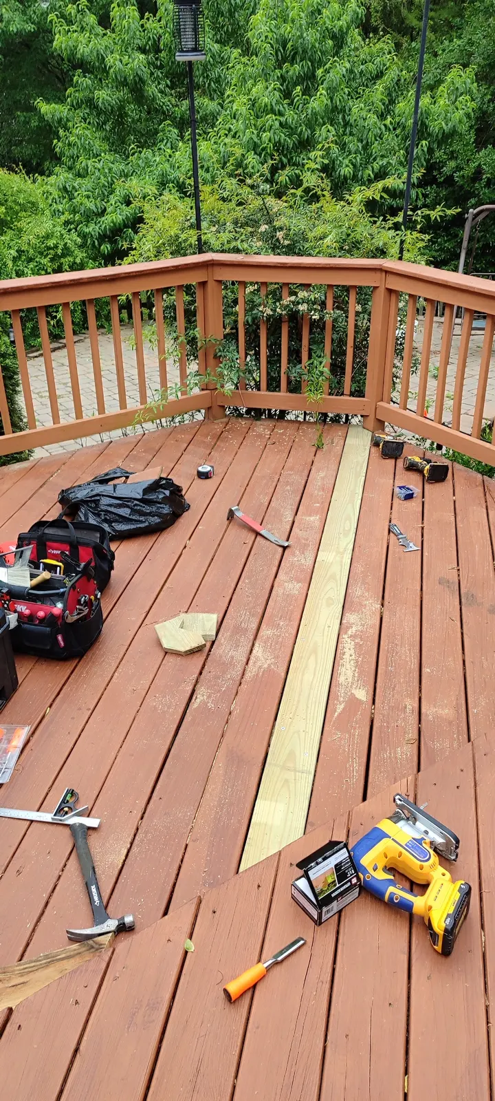 Wider view of the replacement deck board and work area