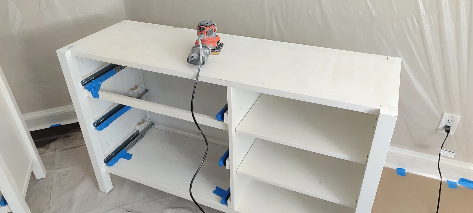 Wide dresser with drawers removed during surface preparation