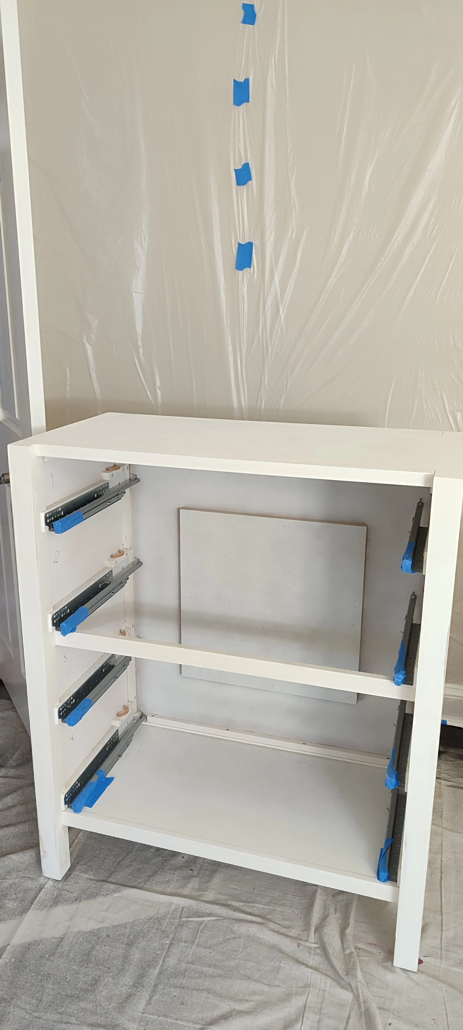 Drawer cabinet with masked slides before repainting