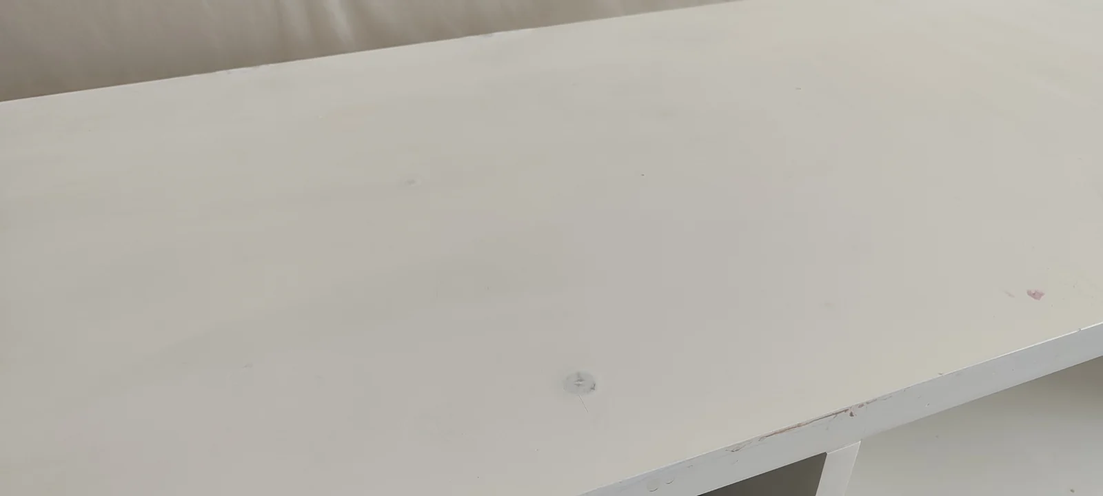 Close view of marks and coating damage on the dresser top