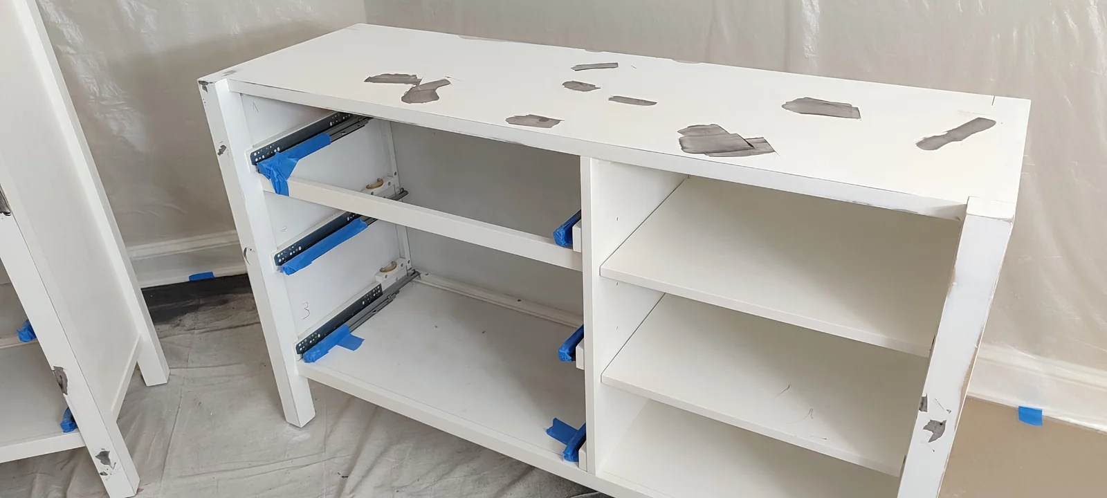 Wide dresser with coating repairs visible across its top and edges