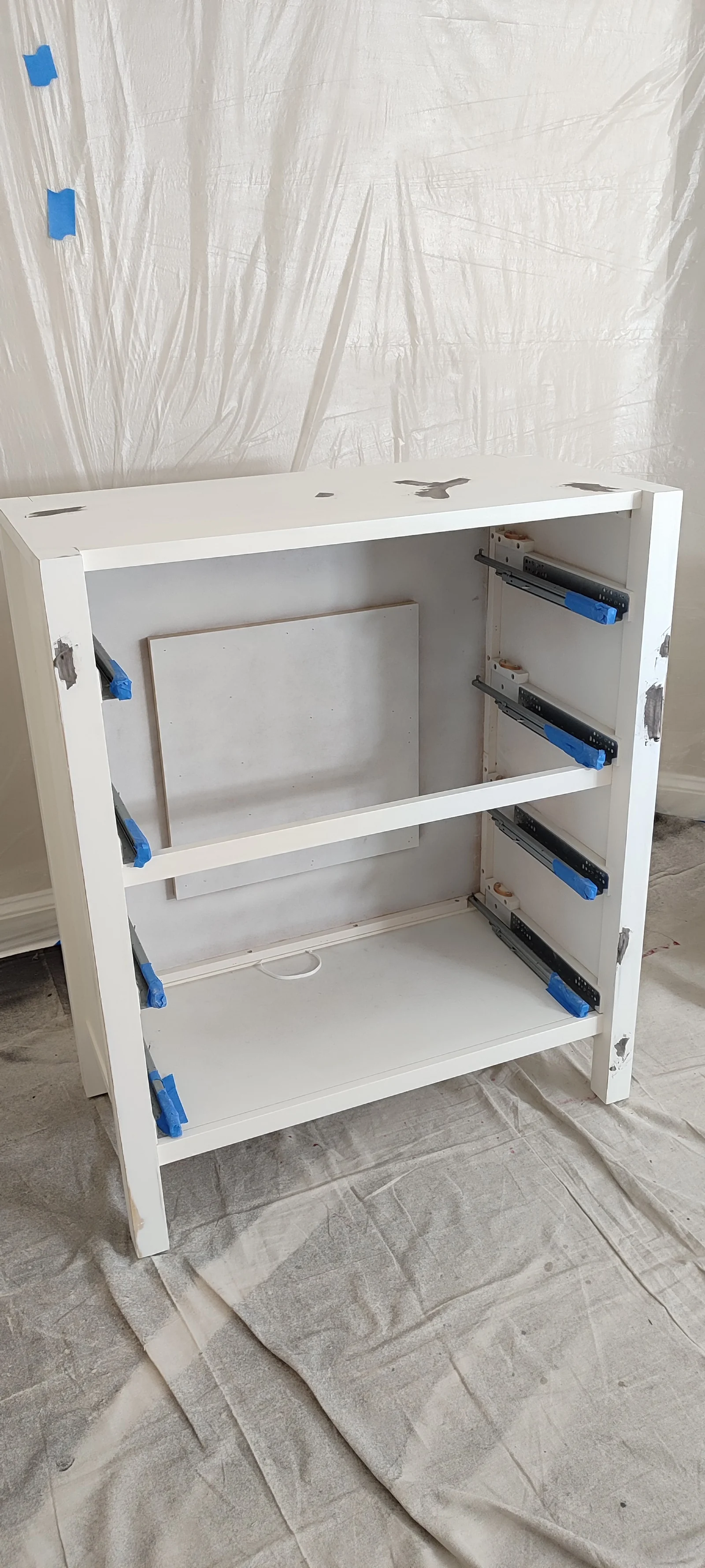 Tall chest with drawers removed during surface preparation