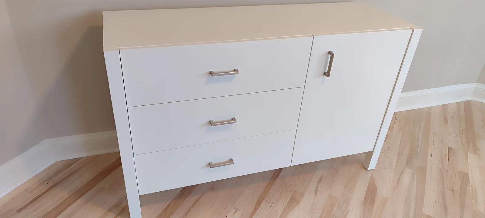 Repainted white dresser with three drawers and a cabinet door