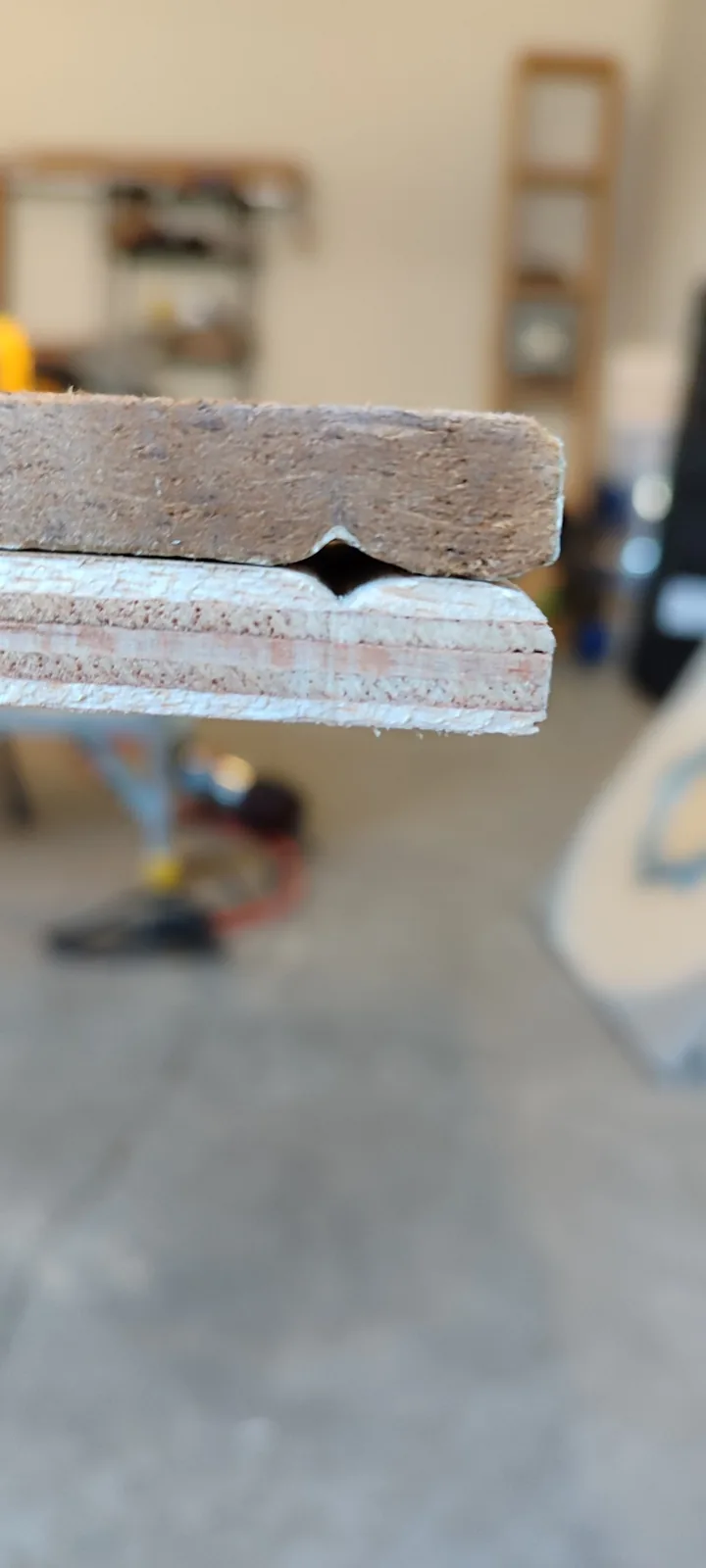 Close view of the decorative siding profile being matched during custom fabrication
