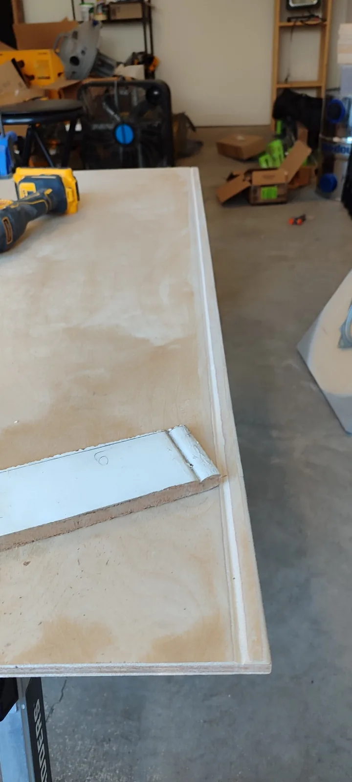 Custom plywood replacement panel shaped to reproduce the existing siding profile