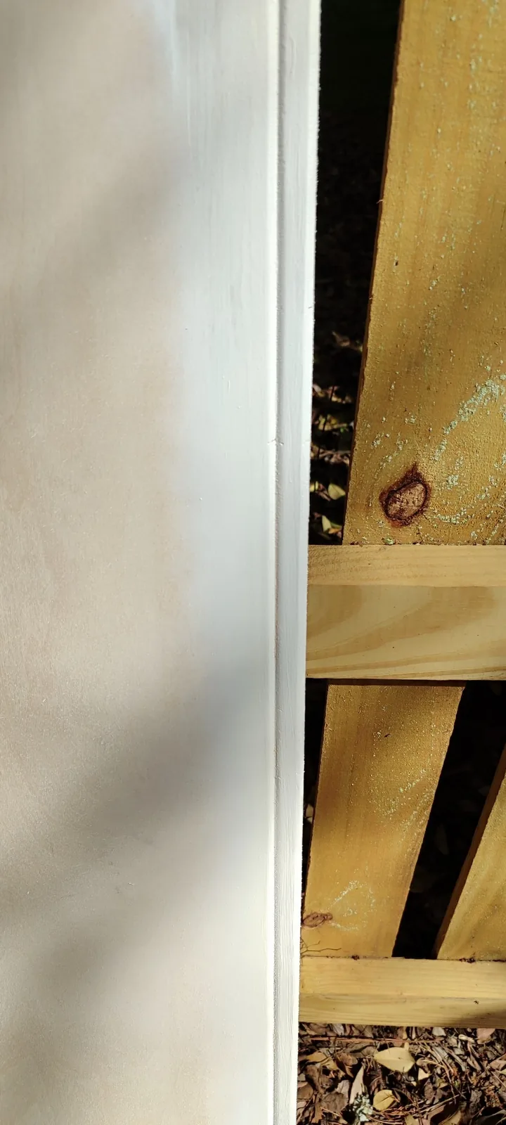 Close view of the routed decorative edge on a primed replacement siding panel