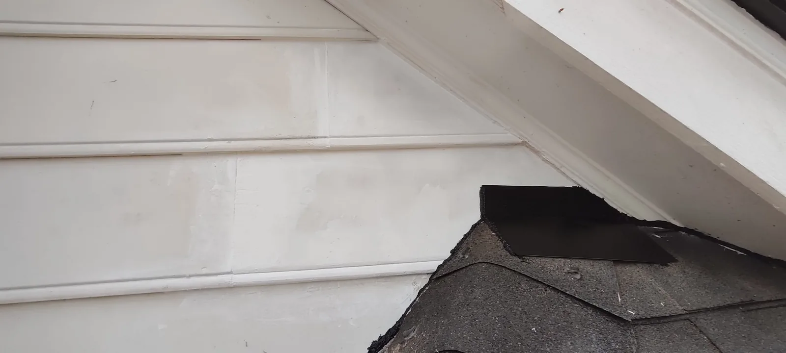 Replacement siding panel installed and aligned with the existing exterior boards