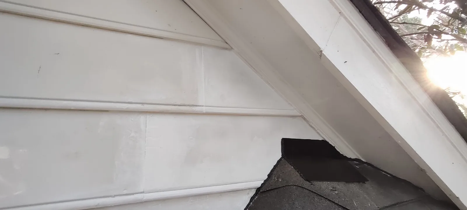 Custom siding repair fitted around the roof intersection before final sealing