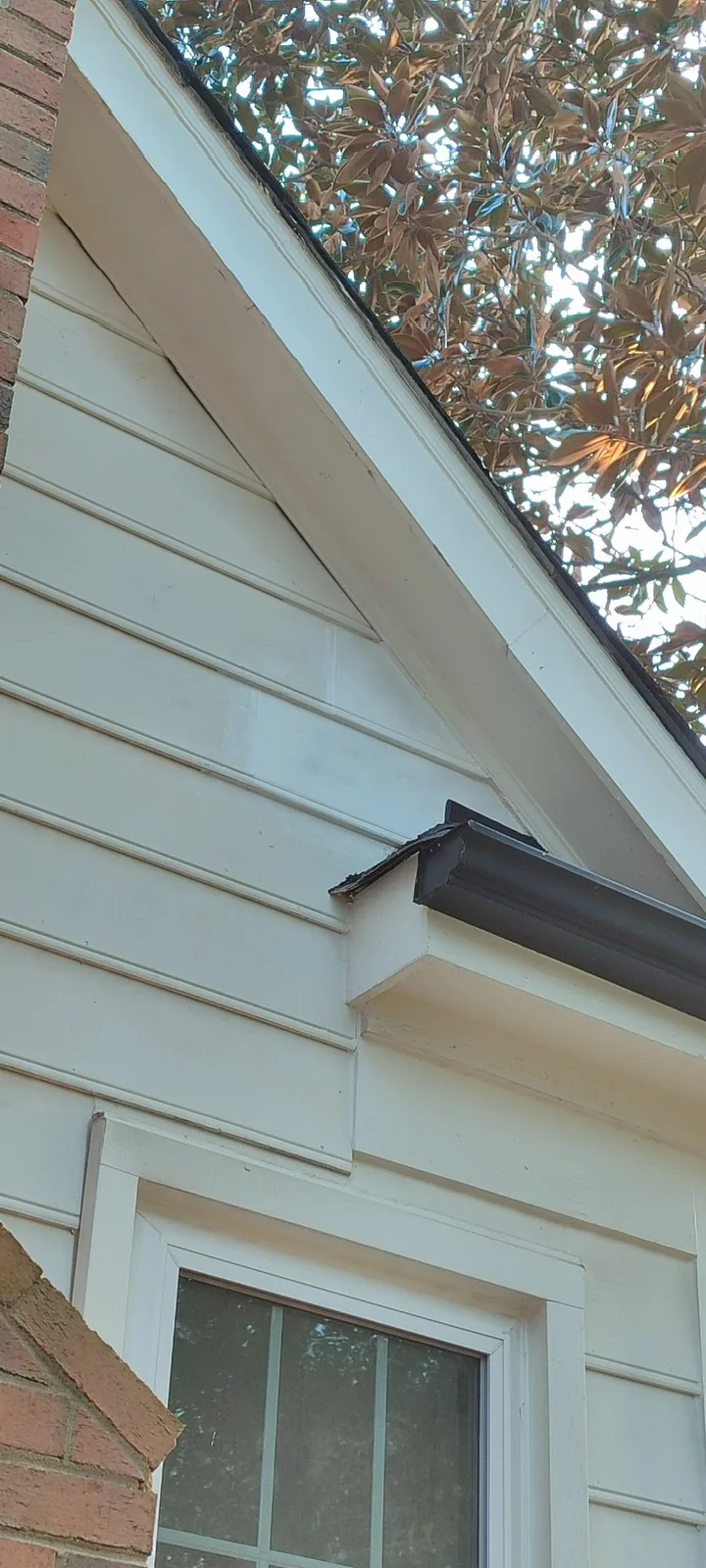 Completed custom siding panel repair beside the small roof section