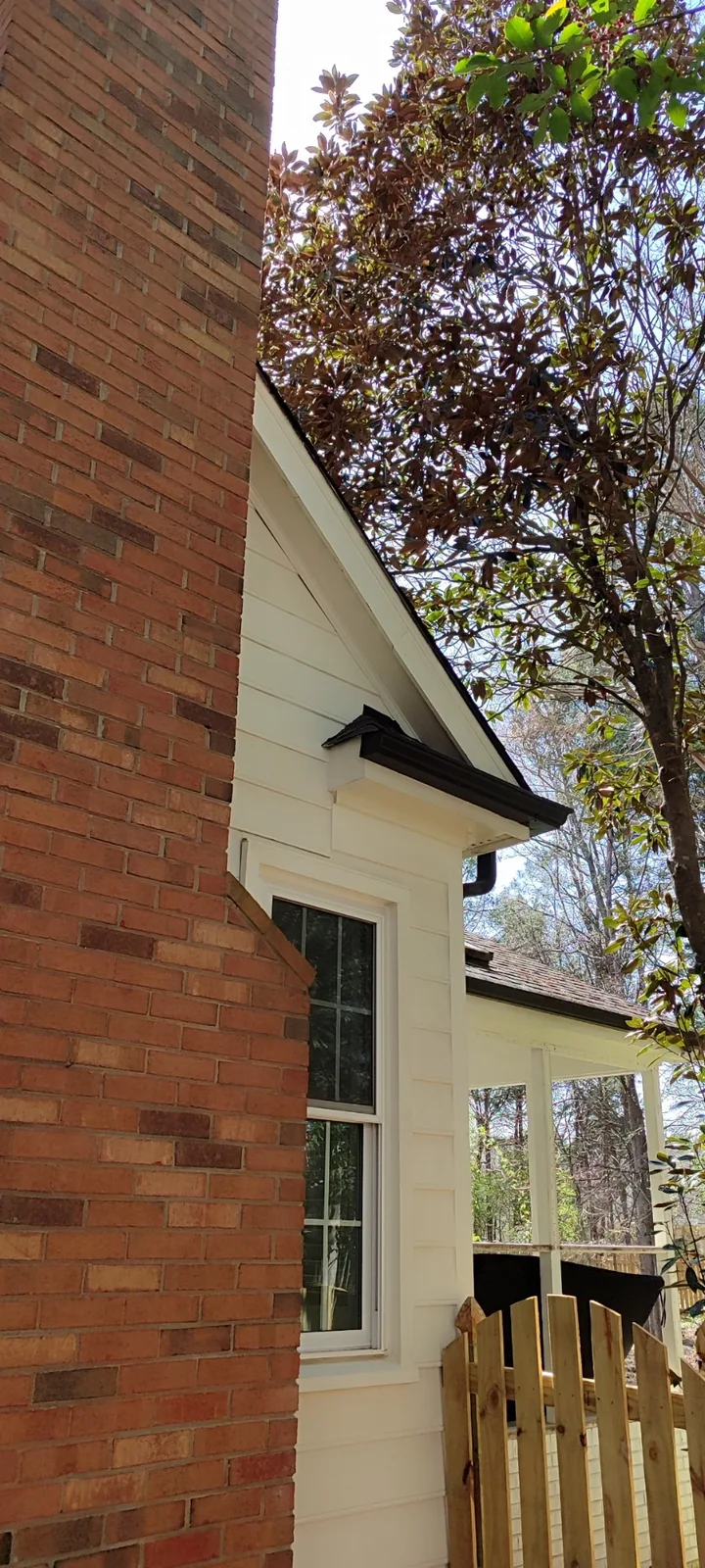 Completed exterior siding repair blended with the surrounding wall panels
