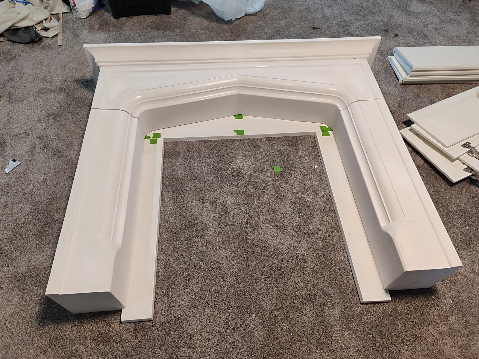 Decorative fireplace mantel components before installation.