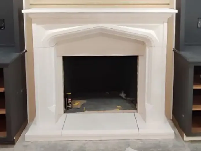 Fireplace after mantel repair and decorative trim installation.