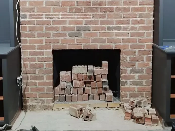 Brick fireplace before the decorative mantel was restored.