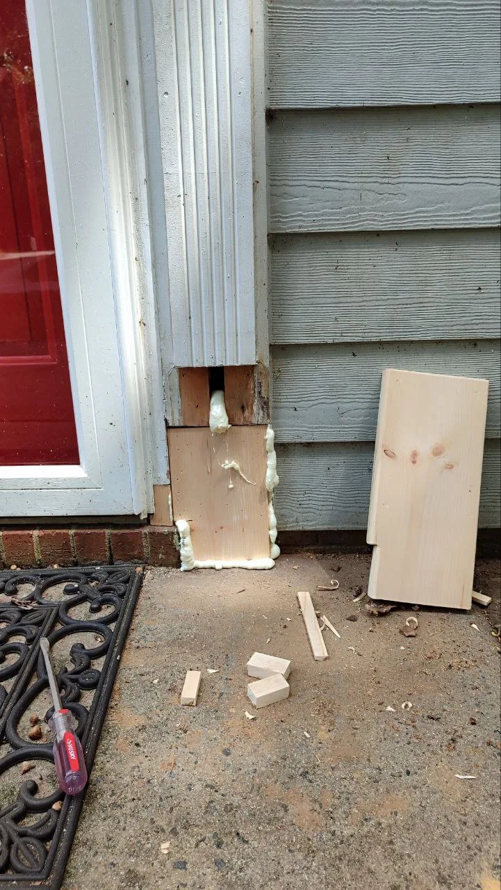Damaged door trim removed before installing a replacement section.
