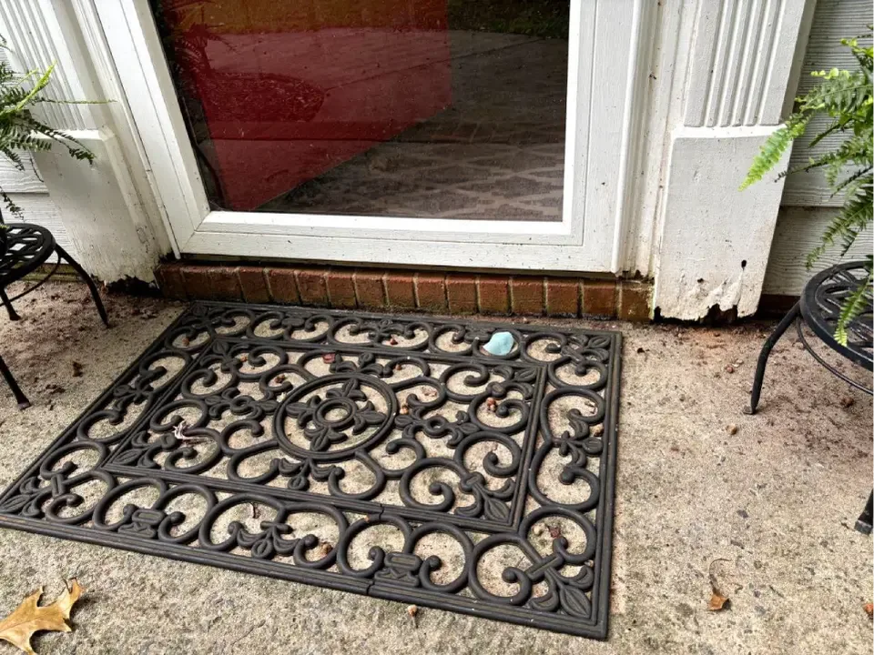 Damaged lower front door trim before repair.