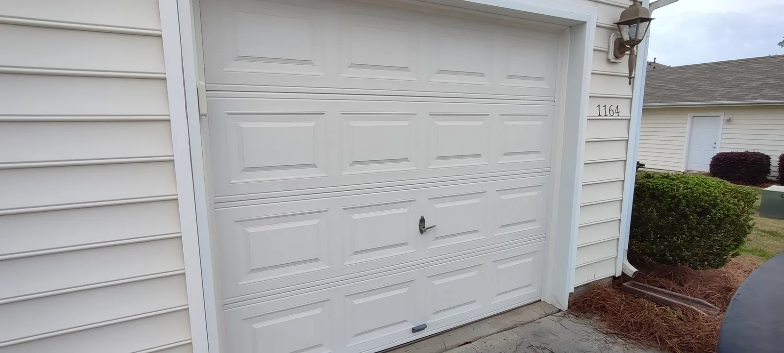 Garage door after exterior weather seal replacement, full view.