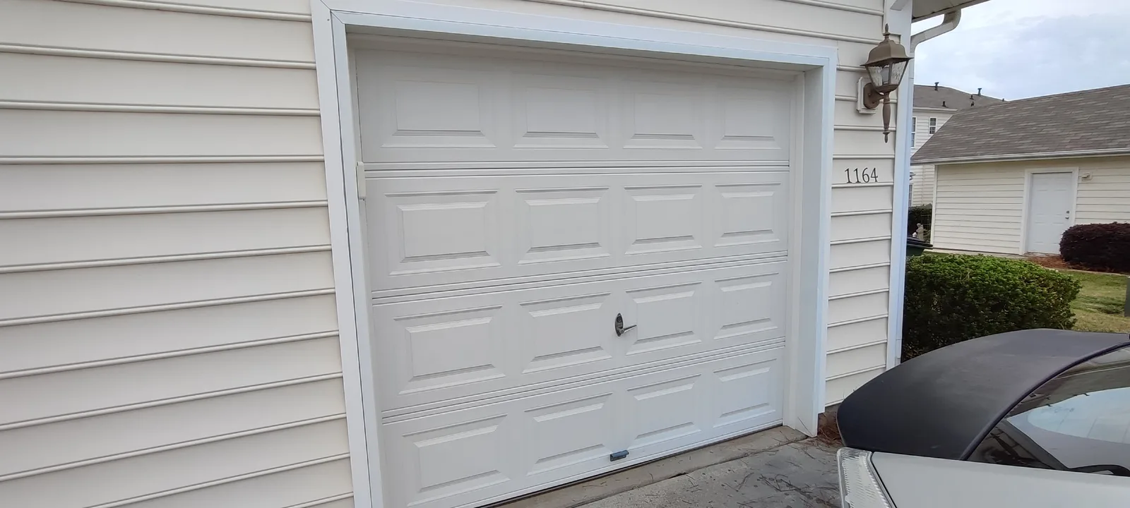 Garage door with a new weather seal installed along the side of the opening.