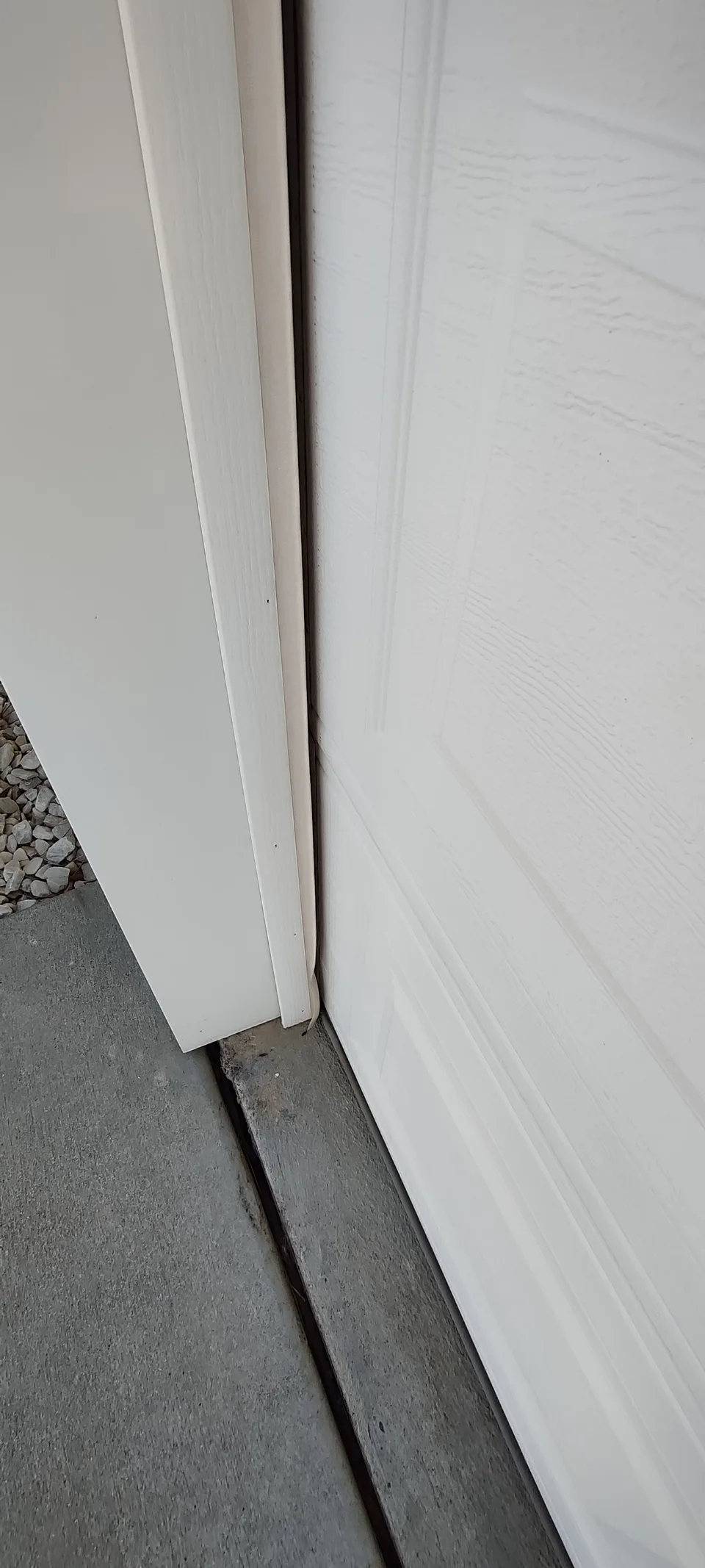 Worn weather seal near the lower section of the garage door before replacement.