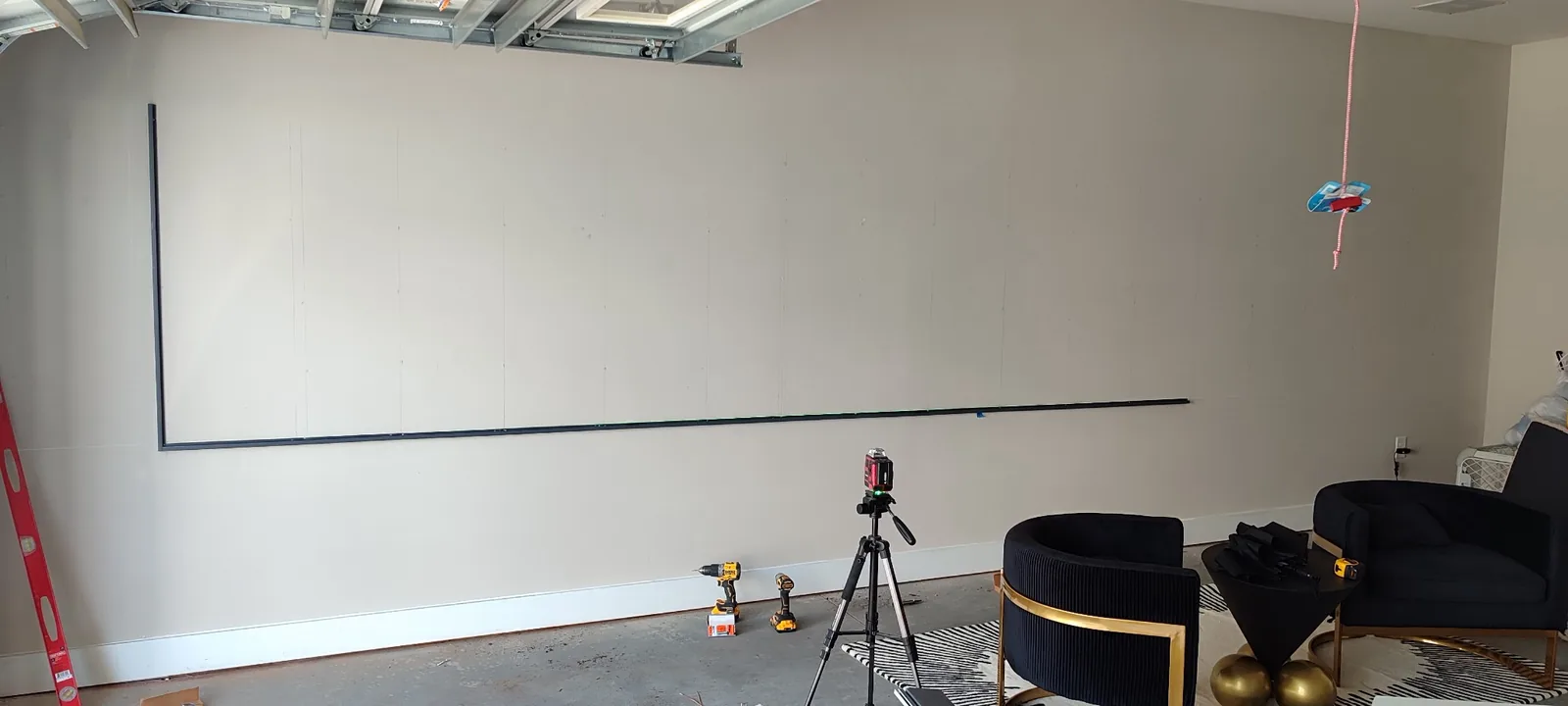 Initial slatwall layout and alignment work on a large garage wall