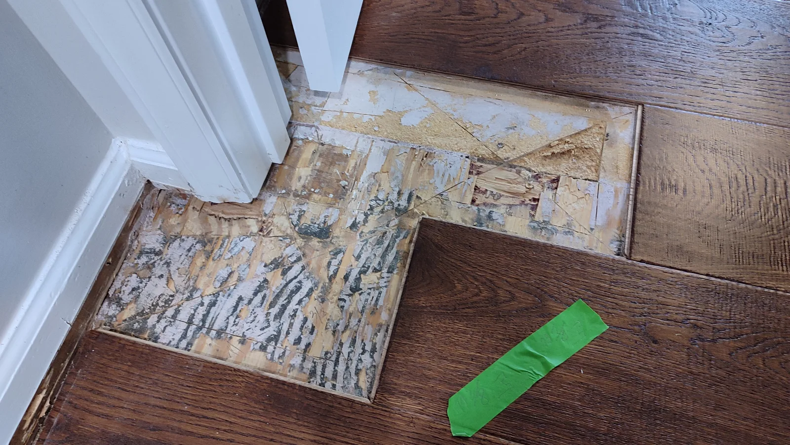 Prepared floor area and replacement hardwood board before fitting.