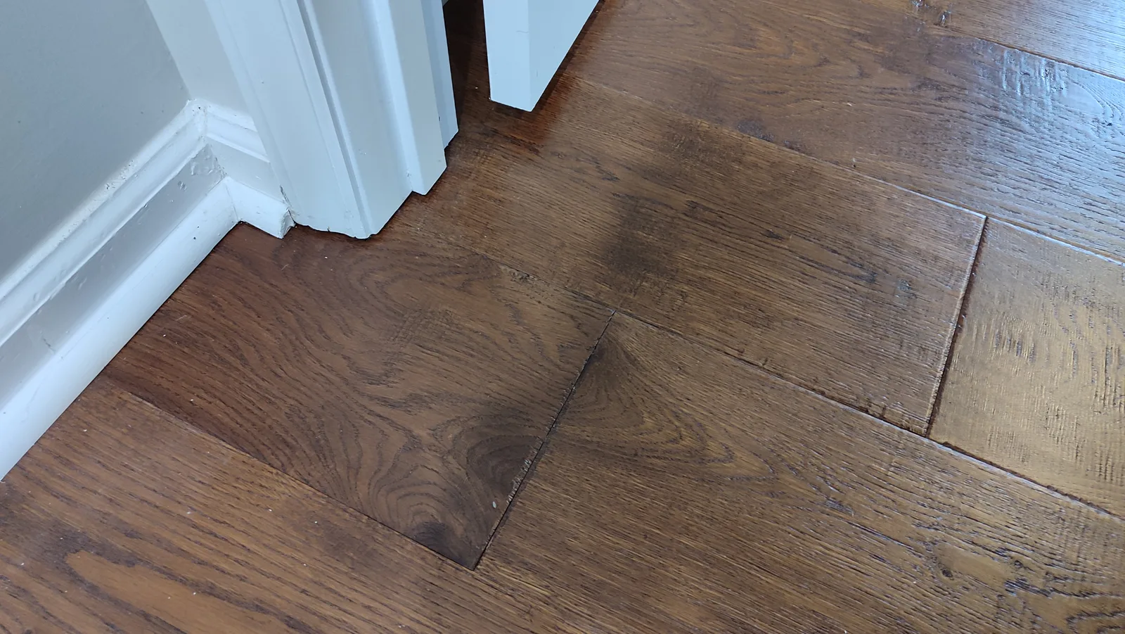 Hardwood flooring at the doorway after local replacement and fitting.