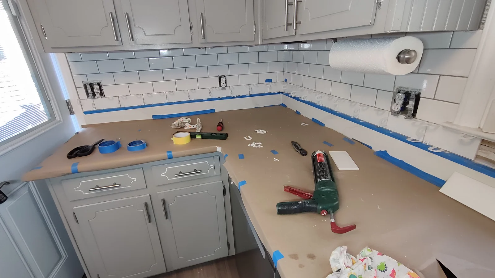 New lower backsplash tiles installed at the left counter corner
