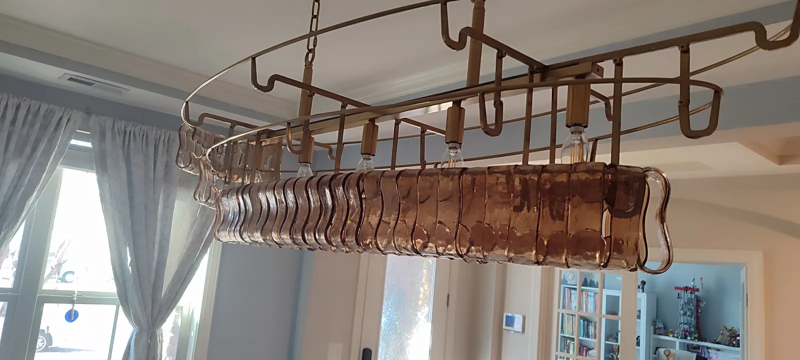 Decorative glass pieces being added to the chandelier frame
