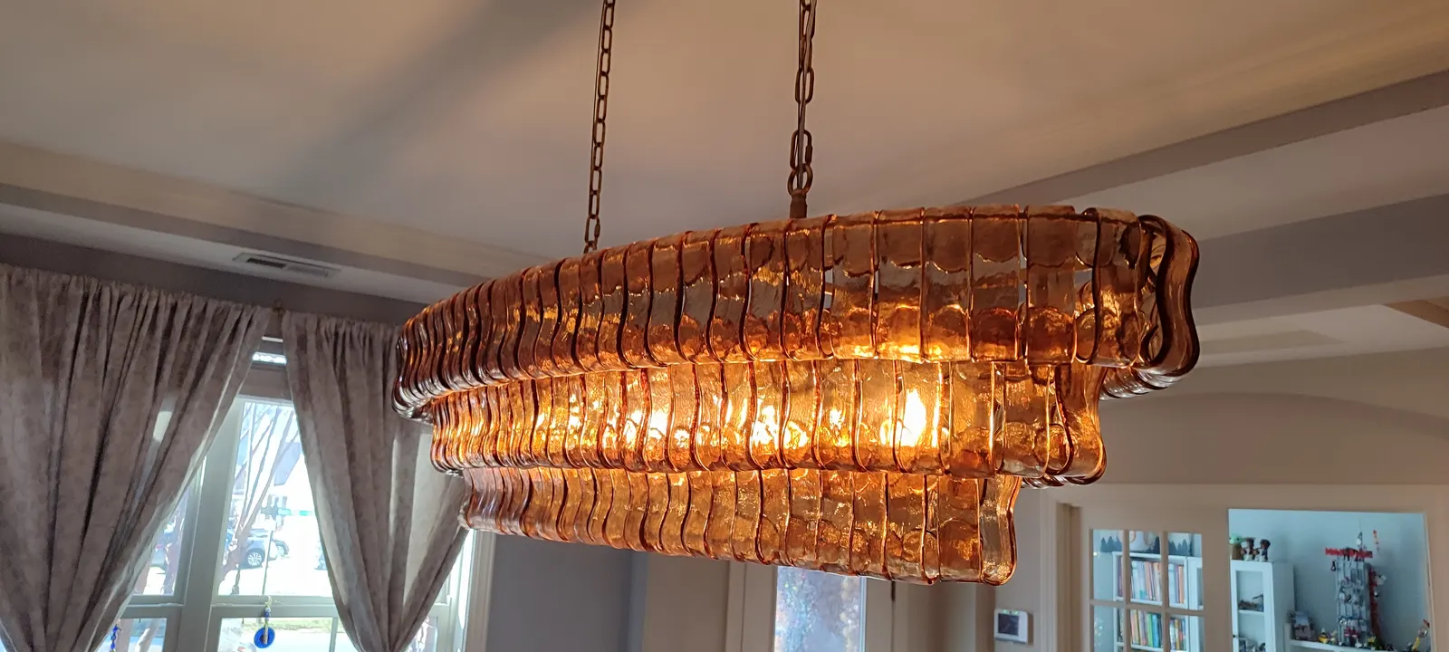 Completed chandelier illuminated above the dining area