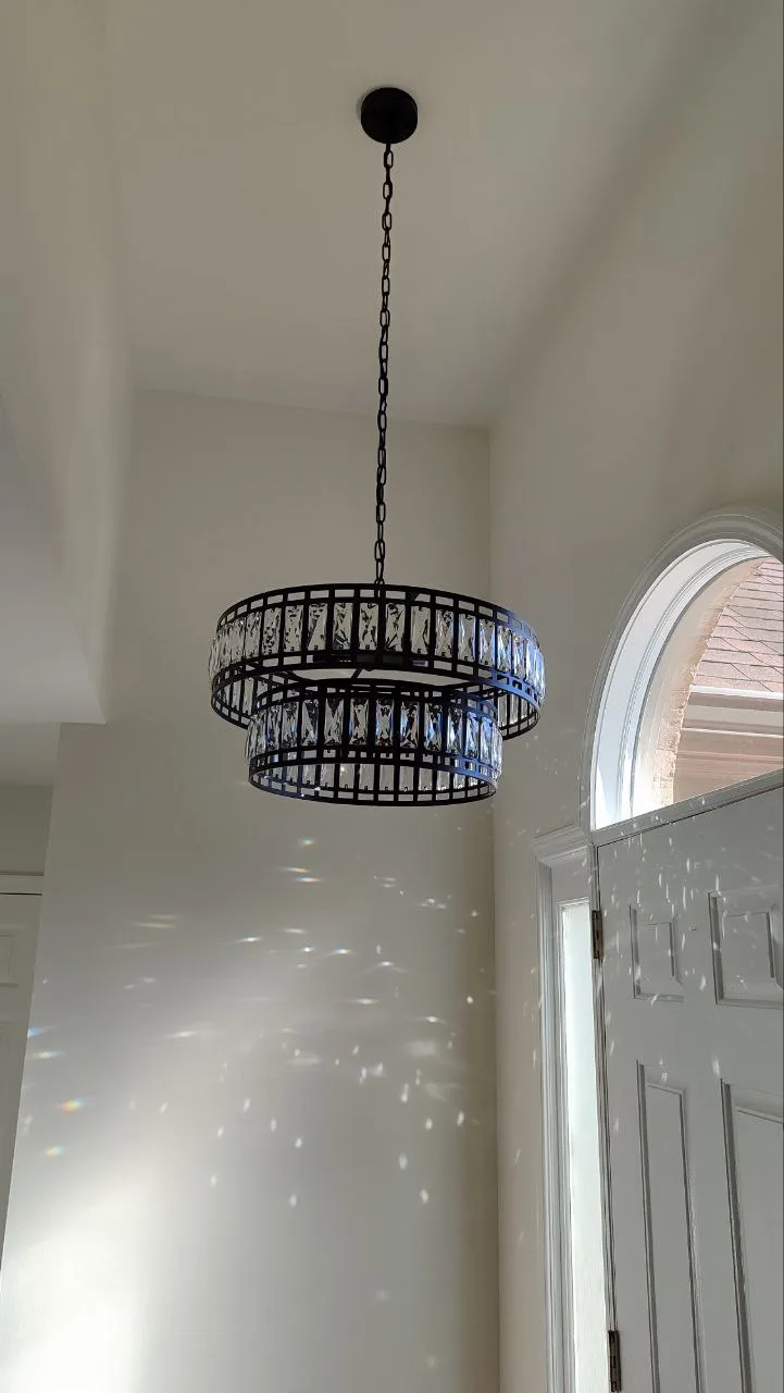 Installed round pendant ceiling light near an entry area.