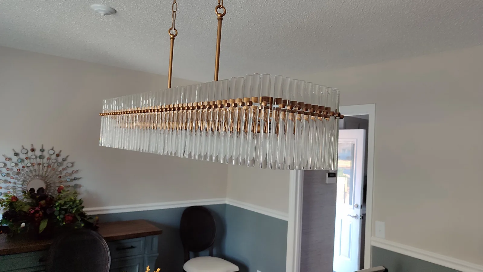 Decorative linear ceiling light with hanging elements after installation.