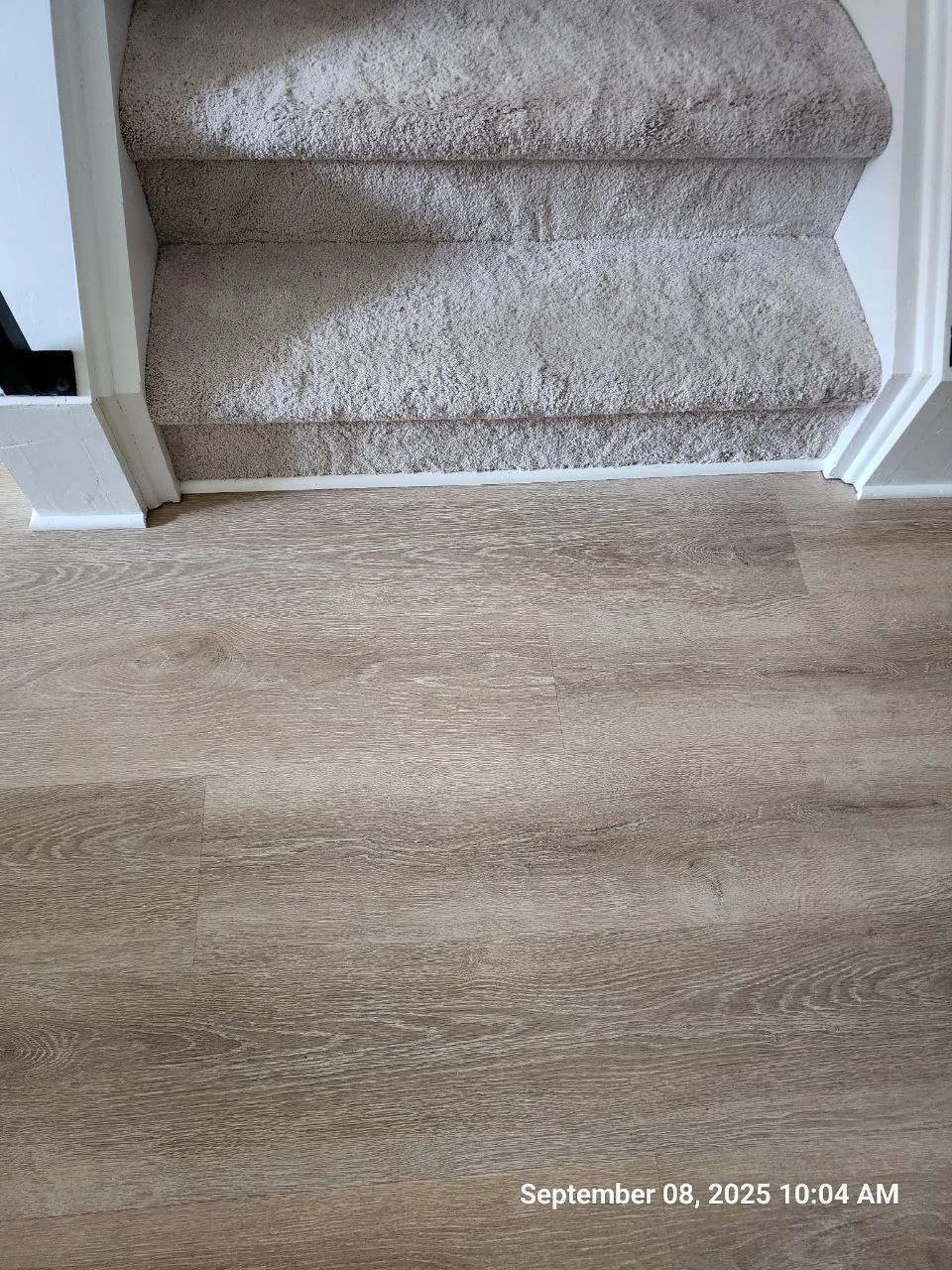 LVP flooring at the stair opening after local repair