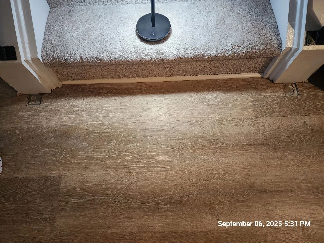 Flooring cutouts at both sides of the stair opening before repair