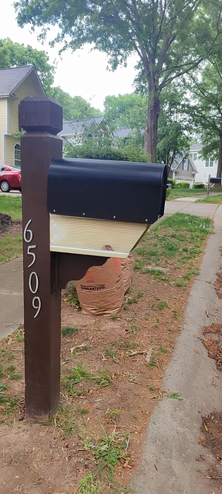 Side view of the repaired woodwork beneath the mailbox