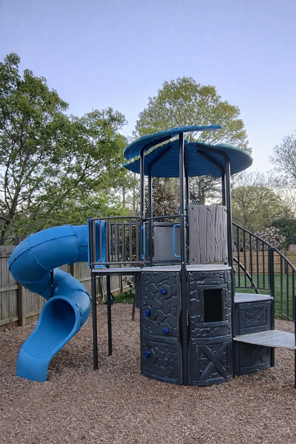 Side view of the playset tower and blue slide