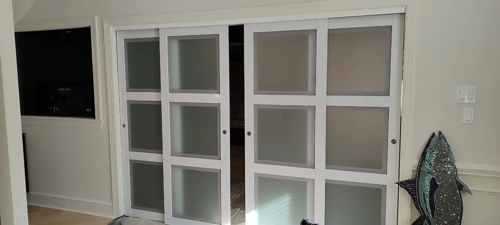 Installed multi-panel sliding doors aligned across the full-width interior opening