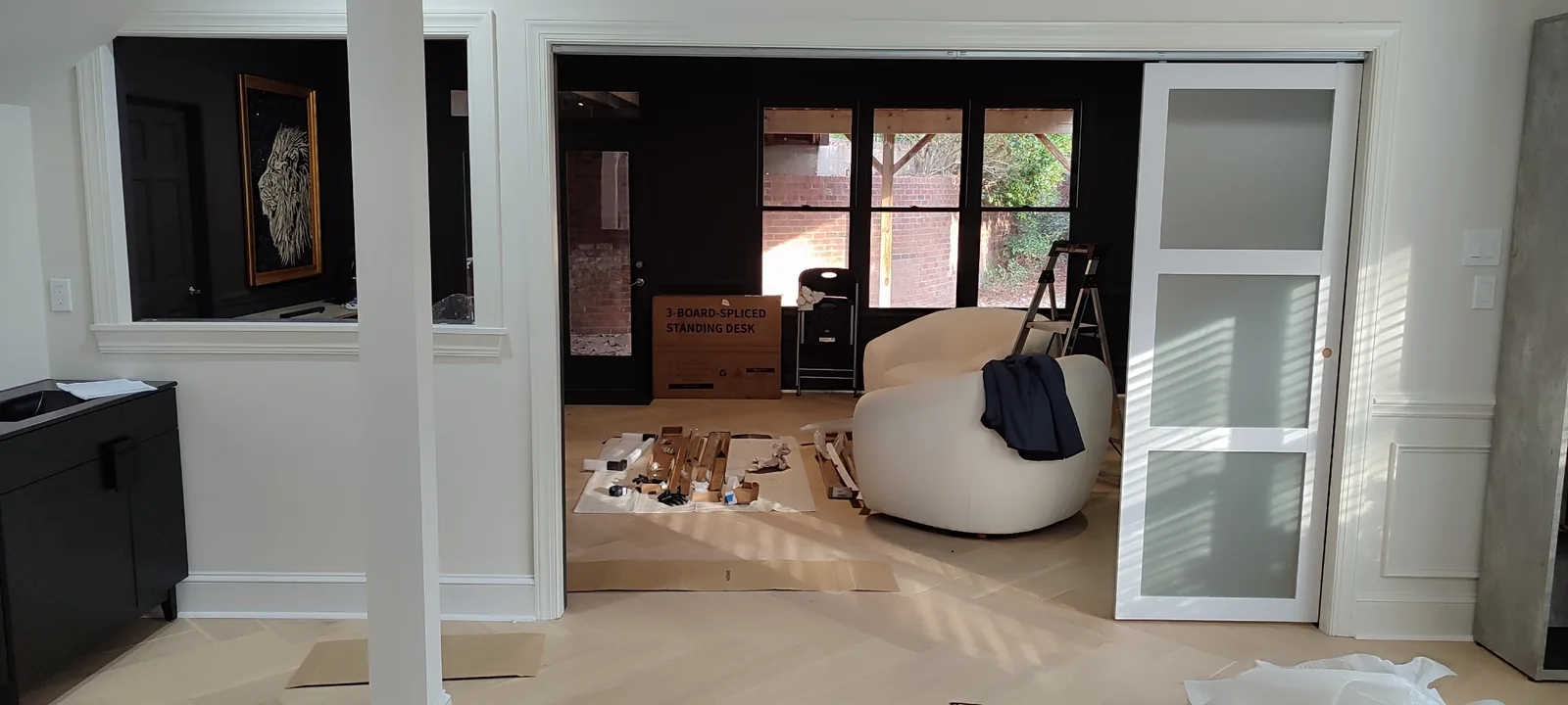Sliding door panels stacked to one side, showing the top-hung track system and open passage