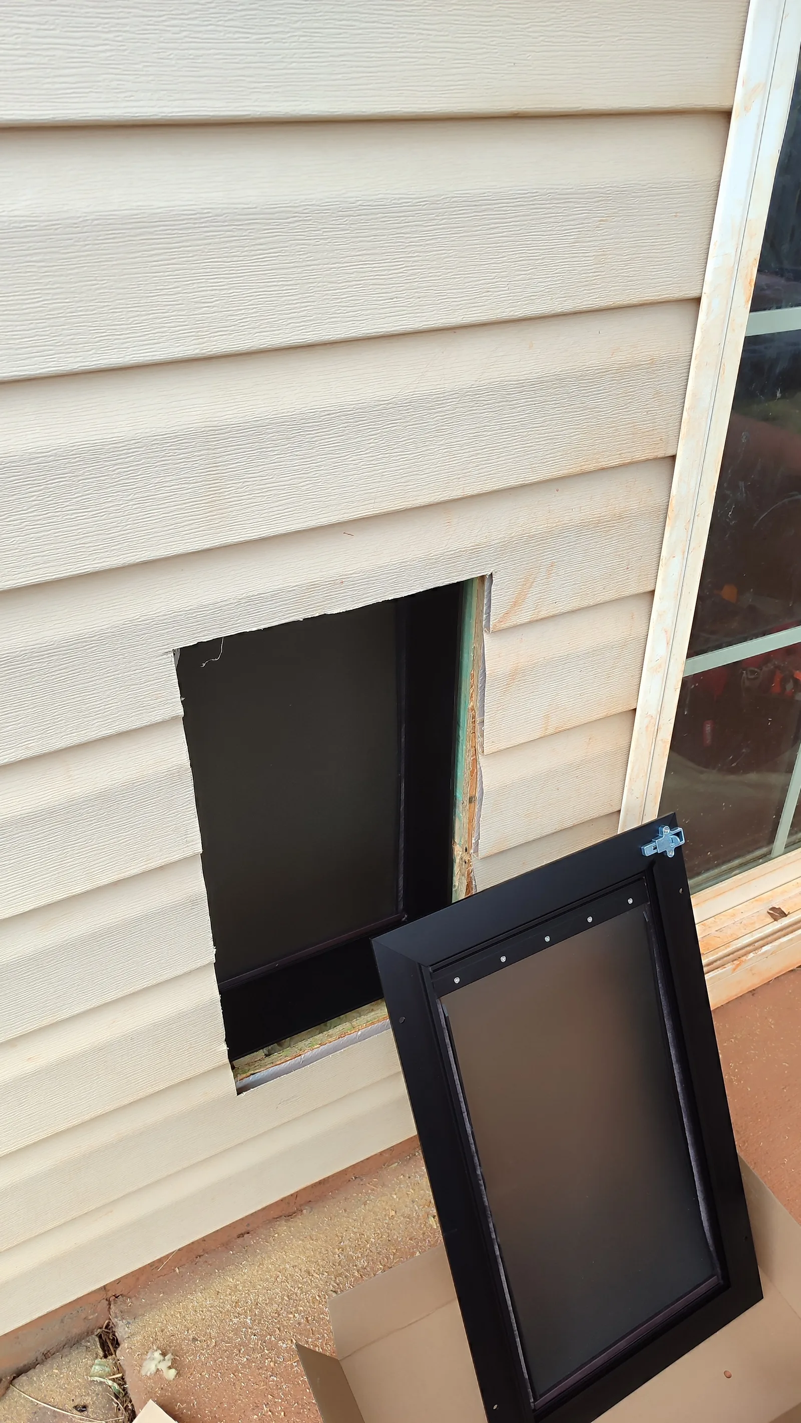 Pet door opening through the exterior wall during installation.