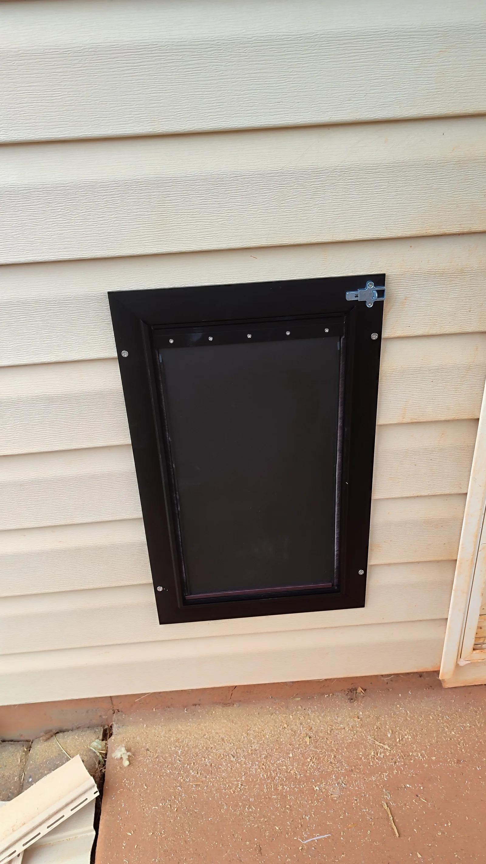 Pet door after installation on the exterior side of the house.